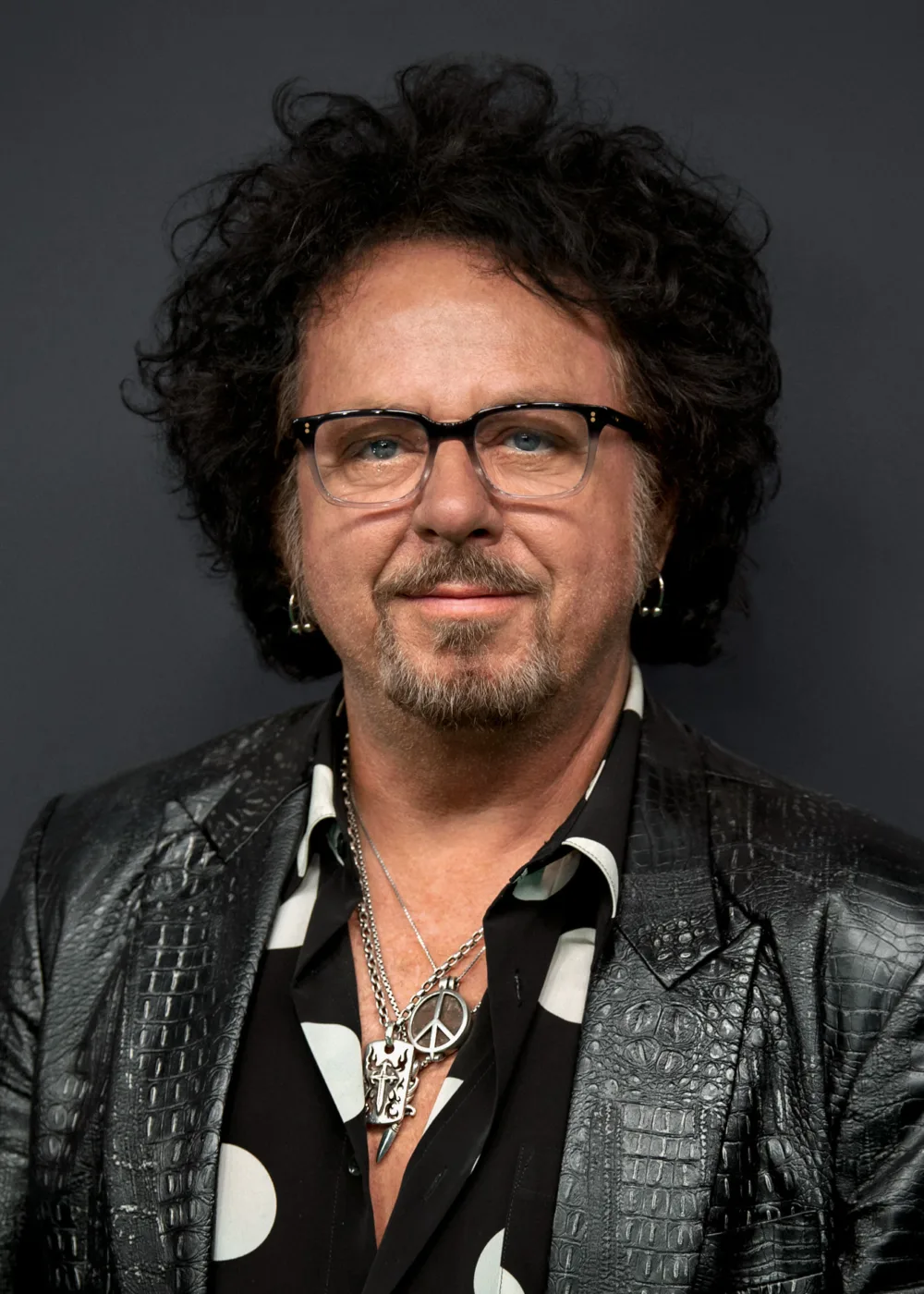Steve Lukather is an American guitarist, singer, songwriter, and record producer. He was born on October 21, 1957, in San Fernando Valley, California. Lukather started playing guitar at the age of seven and became a professional musician in his teens. He is best known as a founding member of the rock band Toto, which he co-founded in 1977. With Toto, Lukather has released multiple albums and won several Grammy Awards. In addition to his work with Toto, Lukather has collaborated with numerous artists, including Michael Jackson, Lionel Richie, Van Halen, Eric Clapton, and Elton John, among others. He has also released several solo albums throughout his career. Lukather is known for his versatile guitar playing style, which incorporates elements of rock, pop, jazz, and blues. He is widely regarded as one of the greatest guitarists of all time and has been inducted into the Musician's Hall of Fame and the Rock and Roll Hall of Fame.