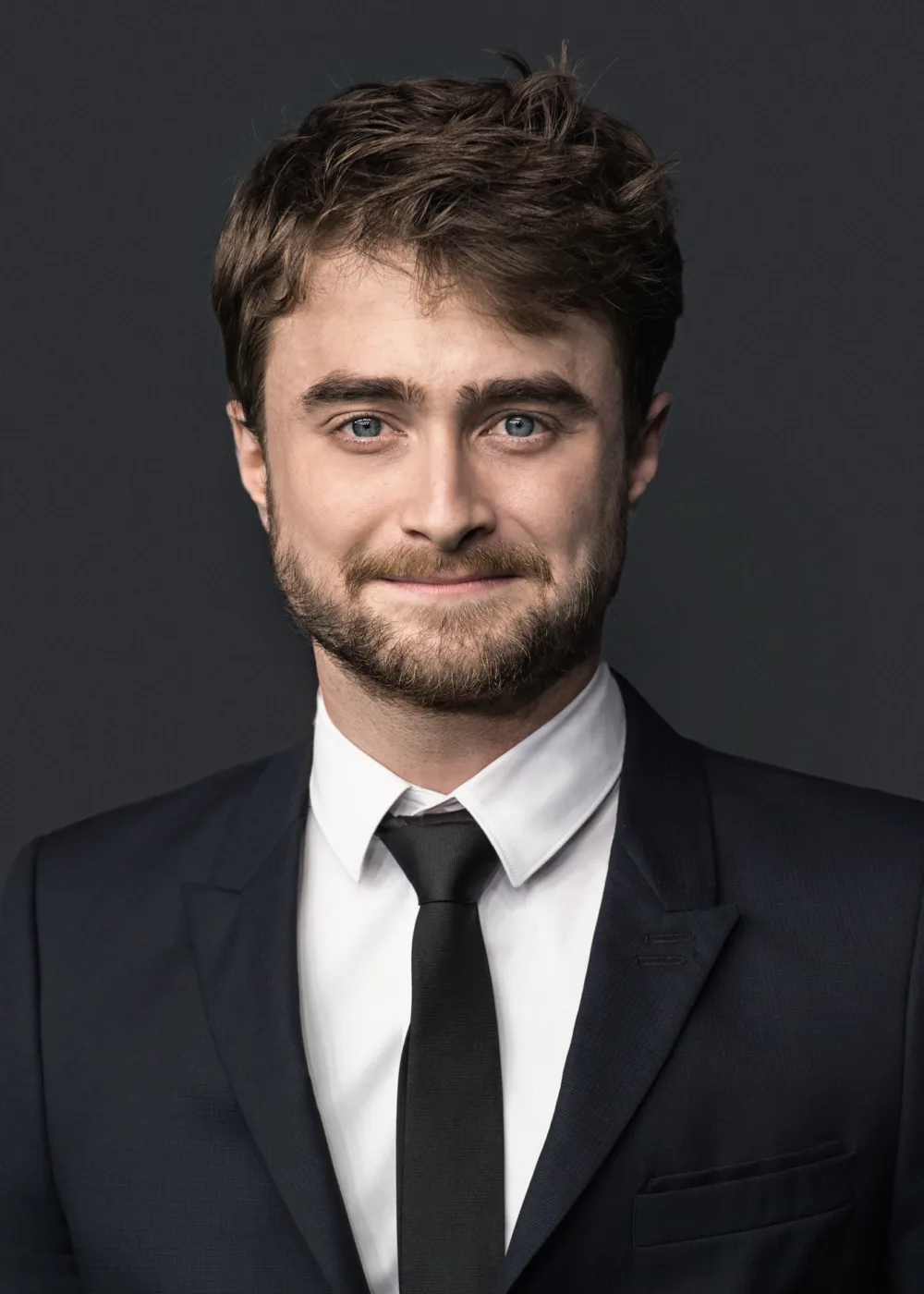 Daniel Radcliffe is an English actor best known for his role as Harry Potter in the film adaptations of J.K. Rowling's beloved book series. Born on July 23, 1989, in London, Radcliffe began acting at a young age and was just eleven years old when he landed the lead role in Harry Potter and the Philosopher's Stone, the first film in the series. Over the course of the next decade, Radcliffe starred in all eight Harry Potter films, becoming one of the most recognizable and beloved actors of his generation. Since the conclusion of the Harry Potter franchise, Radcliffe has continued to act in a variety of film and television projects, including the critically acclaimed Swiss Army Man and the TBS series Miracle Workers. In addition to his acting work, Radcliffe is known for his philanthropy and advocacy work, supporting a variety of causes including LGBT rights, mental health, and literacy. He has also been recognized for his work on stage, earning critical acclaim for his performances in plays like Equus and The Cripple of Inishmaan. With his talent, charm, and dedication to making a difference in the world, Radcliffe has become a beloved figure in the entertainment industry and a role model for young people around the world.