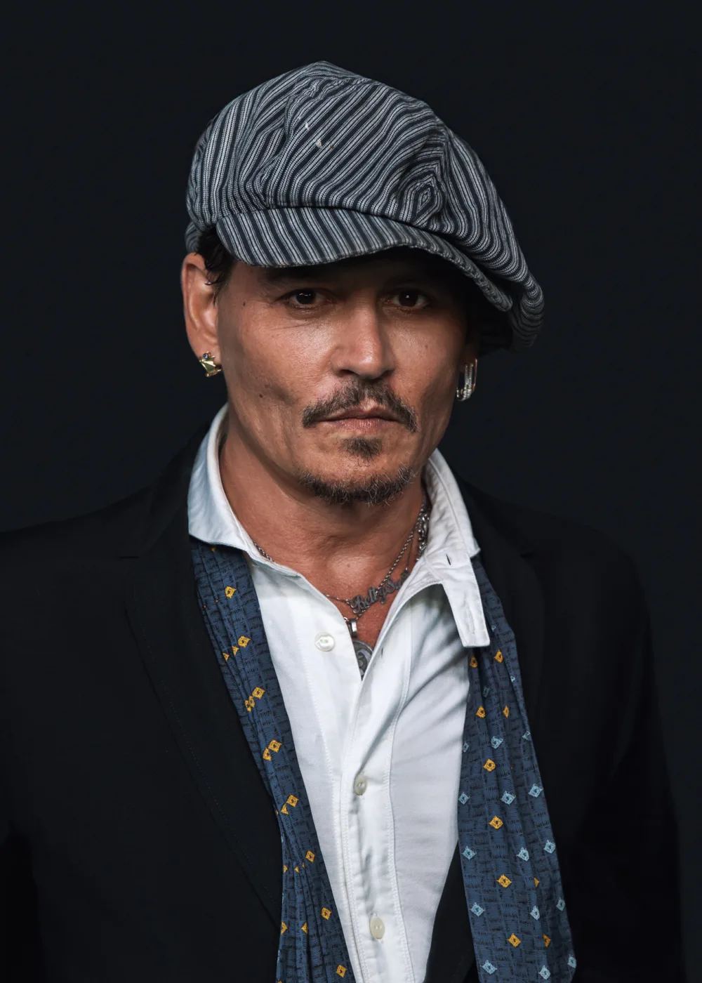 Johnny Depp is a versatile American actor, producer, and musician known for his iconic performances in a range of films. Born on June 9, 1963, in Owensboro, Kentucky, Depp began his career in the entertainment industry as a musician before transitioning to acting. He gained early recognition for his role on the hit TV show 21 Jump Street, but it was his work in films like Edward Scissorhands, Pirates of the Caribbean, and Sweeney Todd: The Demon Barber of Fleet Street that made him a household name. Depp is known for his ability to inhabit complex and unconventional characters, and has become a cult icon for his portrayals of eccentric and offbeat characters. He has received numerous awards and nominations for his work, including three Academy Award nominations and a Golden Globe Award. In addition to his film work, Depp is also an accomplished musician and has played in several bands over the years. Despite his success, Depp has also faced personal challenges, including a tumultuous and publicized divorce and legal battles. Nonetheless, he remains a respected and influential figure in the entertainment industry, with a dedicated fanbase around the world.
