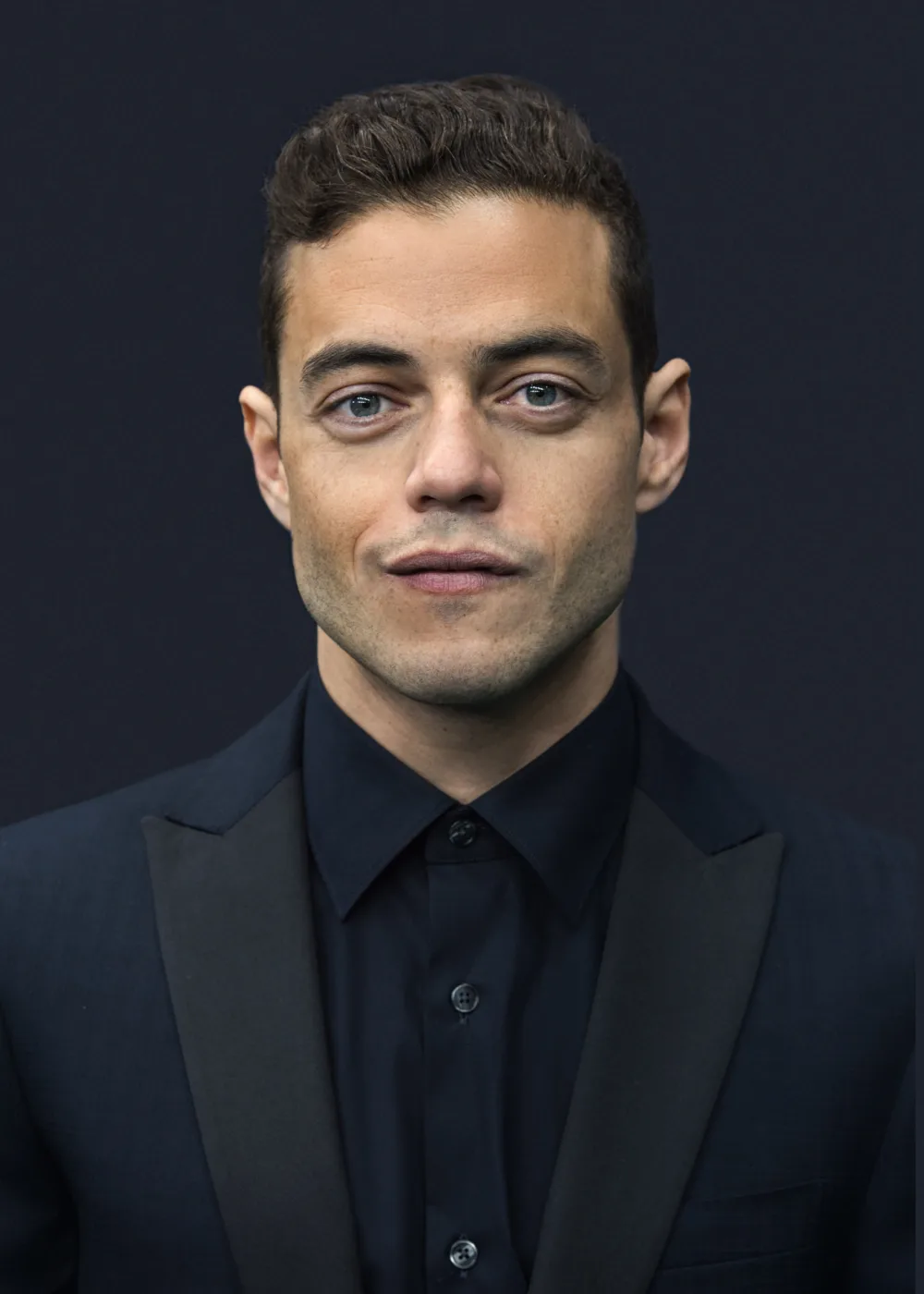 Rami Malek is an American actor known for his transformative performances on both television and film. Born on May 12, 1981, in Los Angeles, California, Malek began his acting career in the early 2000s and rose to prominence with his role as Elliot Alderson in the critically acclaimed television series Mr. Robot. Malek is known for his ability to disappear into his roles and bring a deep sense of authenticity to his characters. He has received widespread critical acclaim for his performances in films such as Bohemian Rhapsody, where he portrayed the iconic musician Freddie Mercury, and No Time to Die, the latest installment in the James Bond film series. In addition to his acting work, Malek is also a passionate advocate for social justice and has used his platform to speak out on issues such as climate change and human rights. He has partnered with organizations such as the United Nations and the World Wildlife Fund to raise awareness and promote positive change. With his talent, intelligence, and dedication to making a positive impact in the world, Malek has become a beloved and influential figure in the entertainment industry, inspiring fans around the world with his performances and his advocacy work.