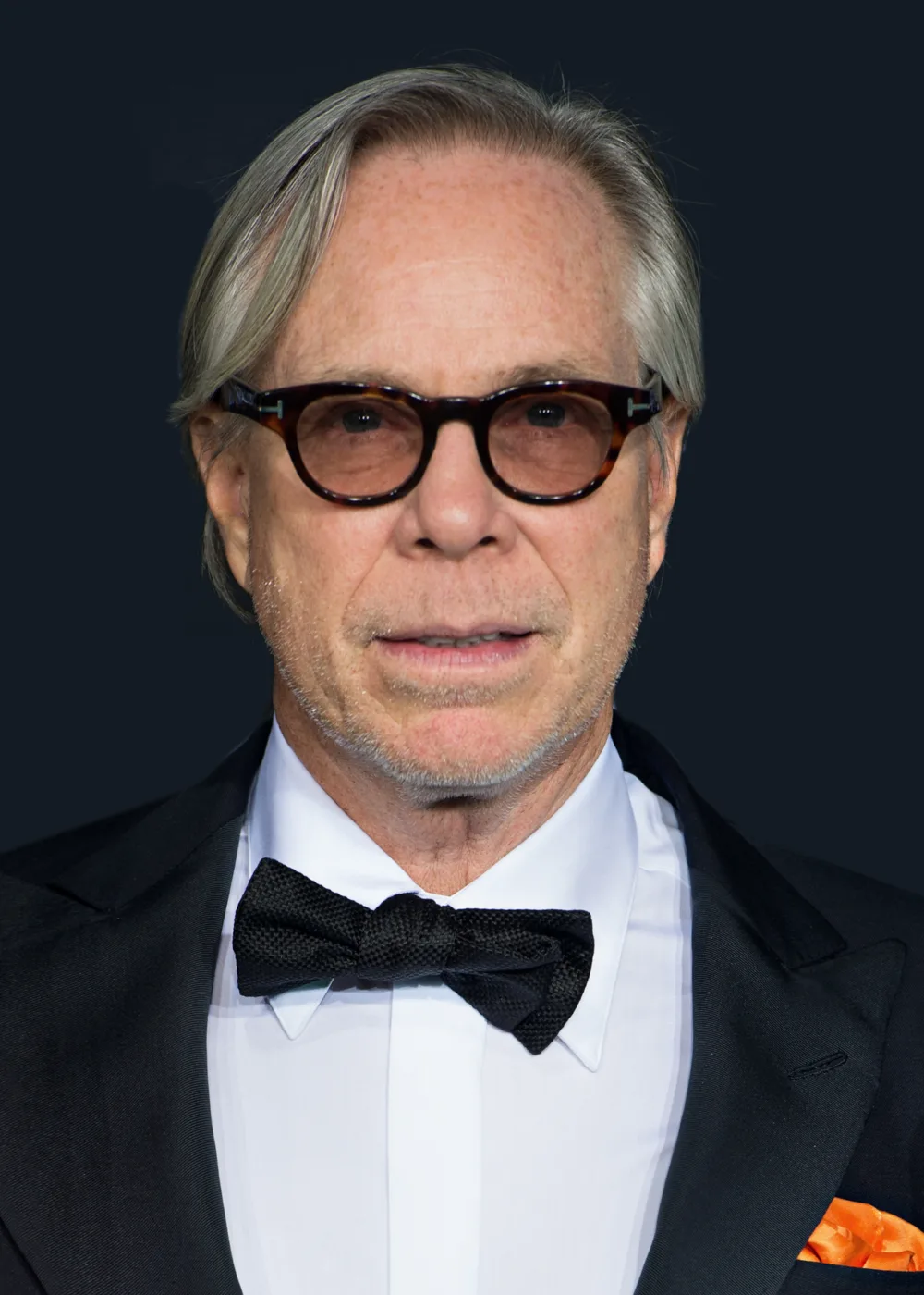 Tommy Hilfiger is an American fashion designer known for creating stylish and high-quality clothing for men, women, and children. He was born on March 24, 1951, in Elmira, New York. Hilfiger started his career in fashion at the age of 18, when he opened his first clothing store. He gained nationwide recognition in the 1990s for his clothing line, which became popular among celebrities and fashion enthusiasts. Throughout his career, Hilfiger has won numerous awards for his contributions to the fashion industry, including the Menswear Designer of the Year award from the Council of Fashion Designers of America. He is also known for his philanthropy work, supporting organizations such as the Breast Health Institute, the Elizabeth Glaser Pediatric AIDS Foundation, and the Anti-Defamation League. Today, Tommy Hilfiger is a global fashion brand, with stores and products sold in countries around the world.